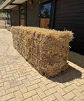 The same big straw bale seen along its length, showing how firmly it is pressed