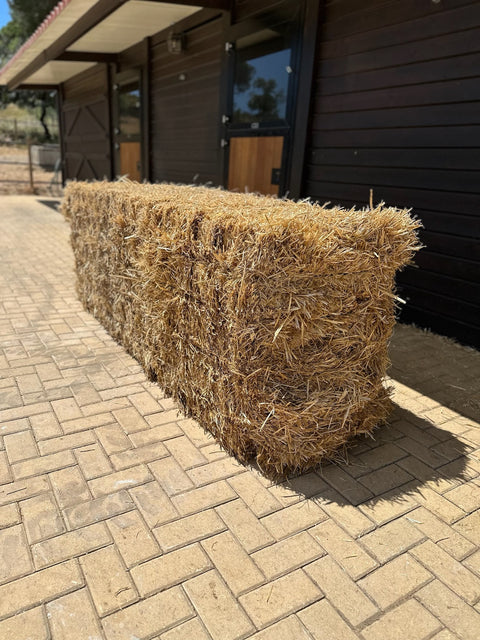 The same big straw bale seen along its length, showing how firmly it is pressed